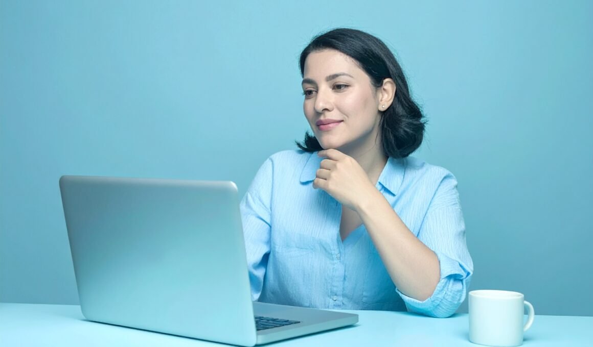 Female blogger sitting in front of laptop