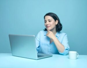 Female blogger sitting in front of laptop