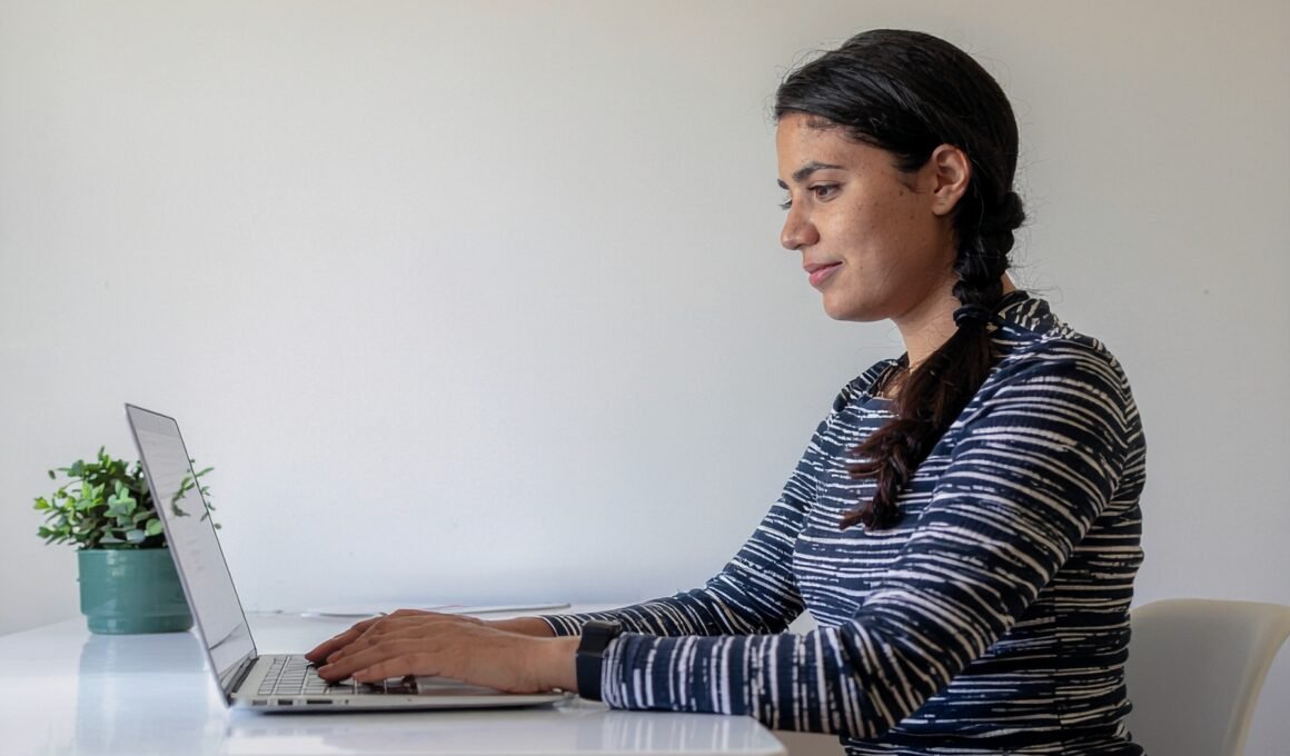 A female sitting typing on a laptop about Micro niche.