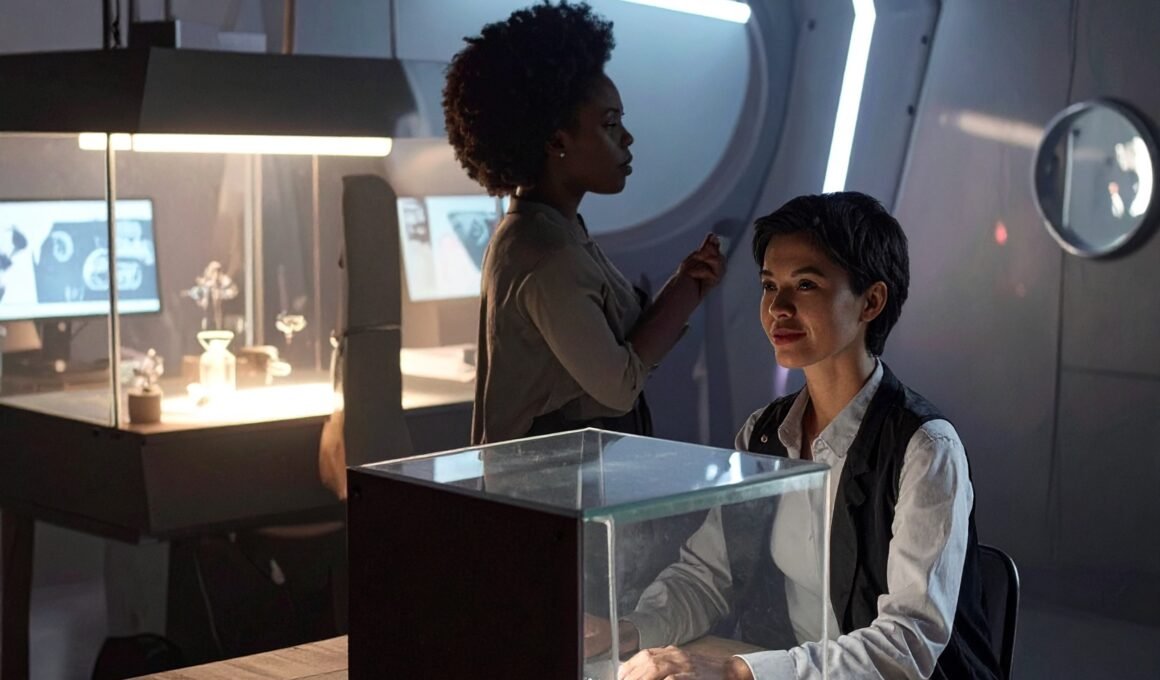 Non-designer careers - females sitting in a laboratory style studio with their hand sin glass cases to denote experimentation.