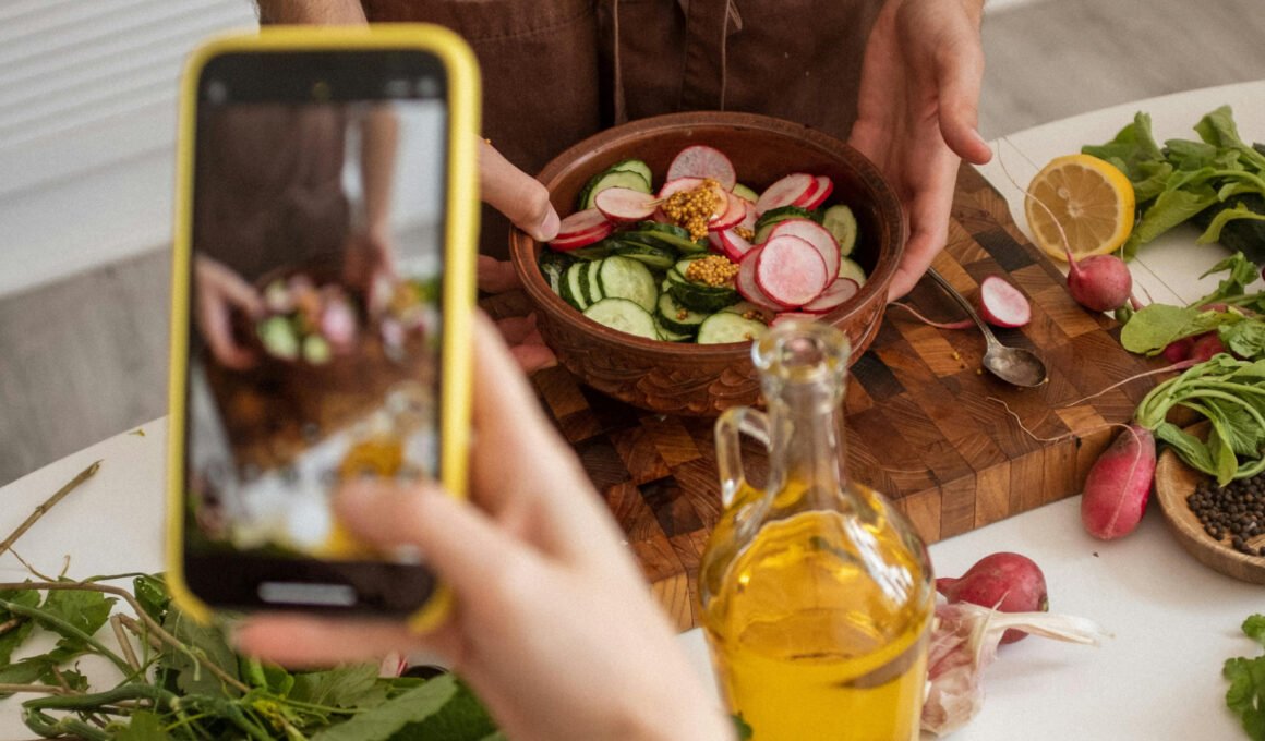 A hand holding a smart taking a photo for a blog. Feature image for How to Start a Blog Without Using Social Media