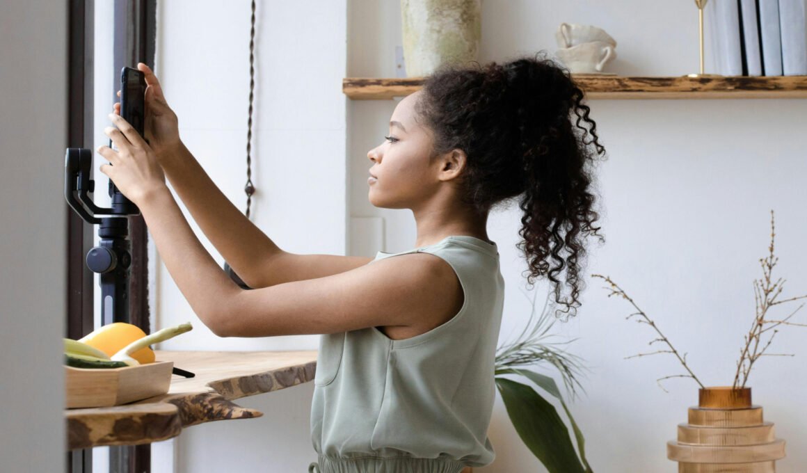 Young biracial or black female setting up her smart phone camera for content creation for article titled: How to Choose a Blog Niche When You Have Too Many Ideas