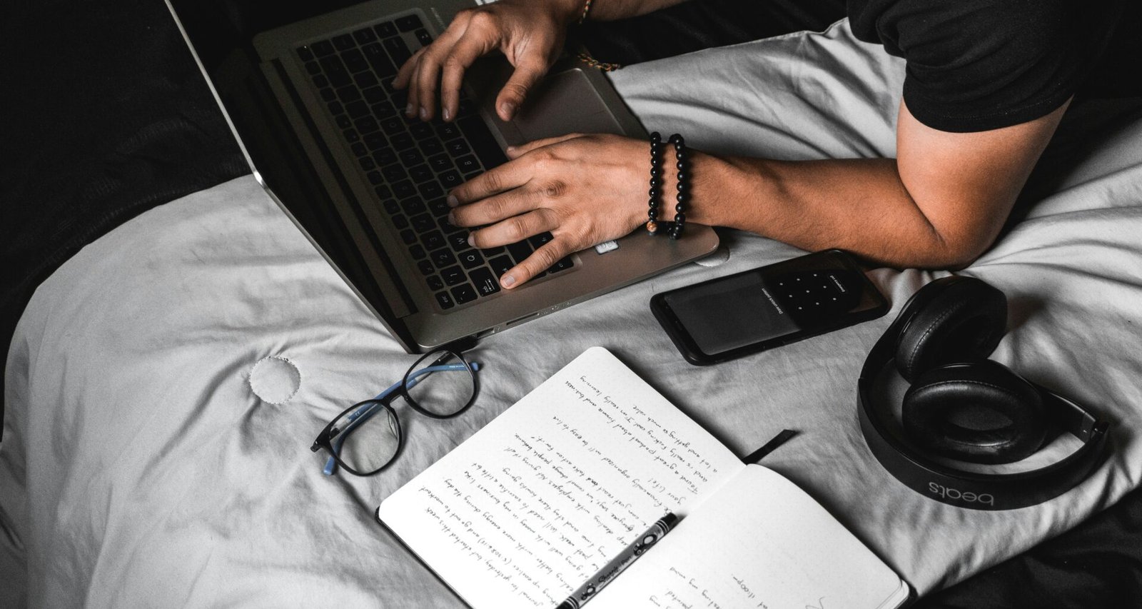 Man typing on laptop representing a side hustle income.