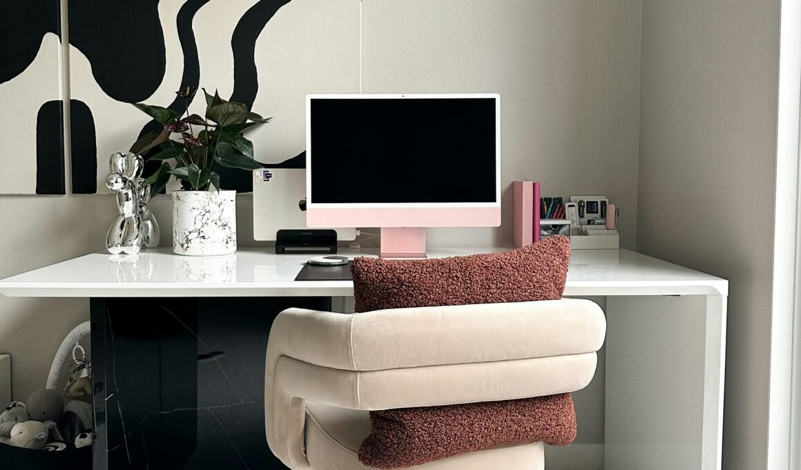 trendy desk with pink apple desktop screen and fashionable chair.