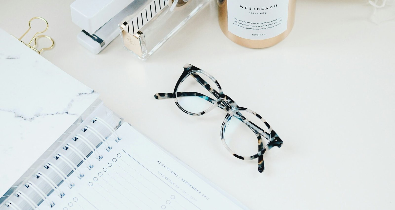 White table top, with glasses, journal - aesthetic look