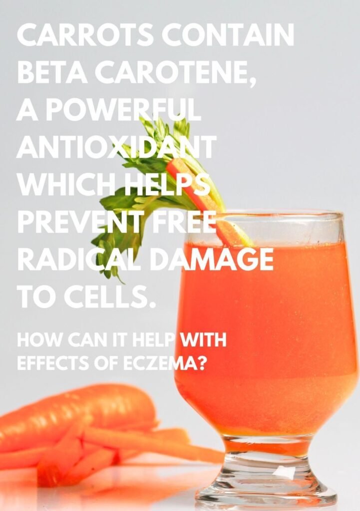 Glass filled with carrot juice with a small carrot sticking in it and carrots lying flat on the surface next to it. Calling out the powerful antioxidant nature of carrots.