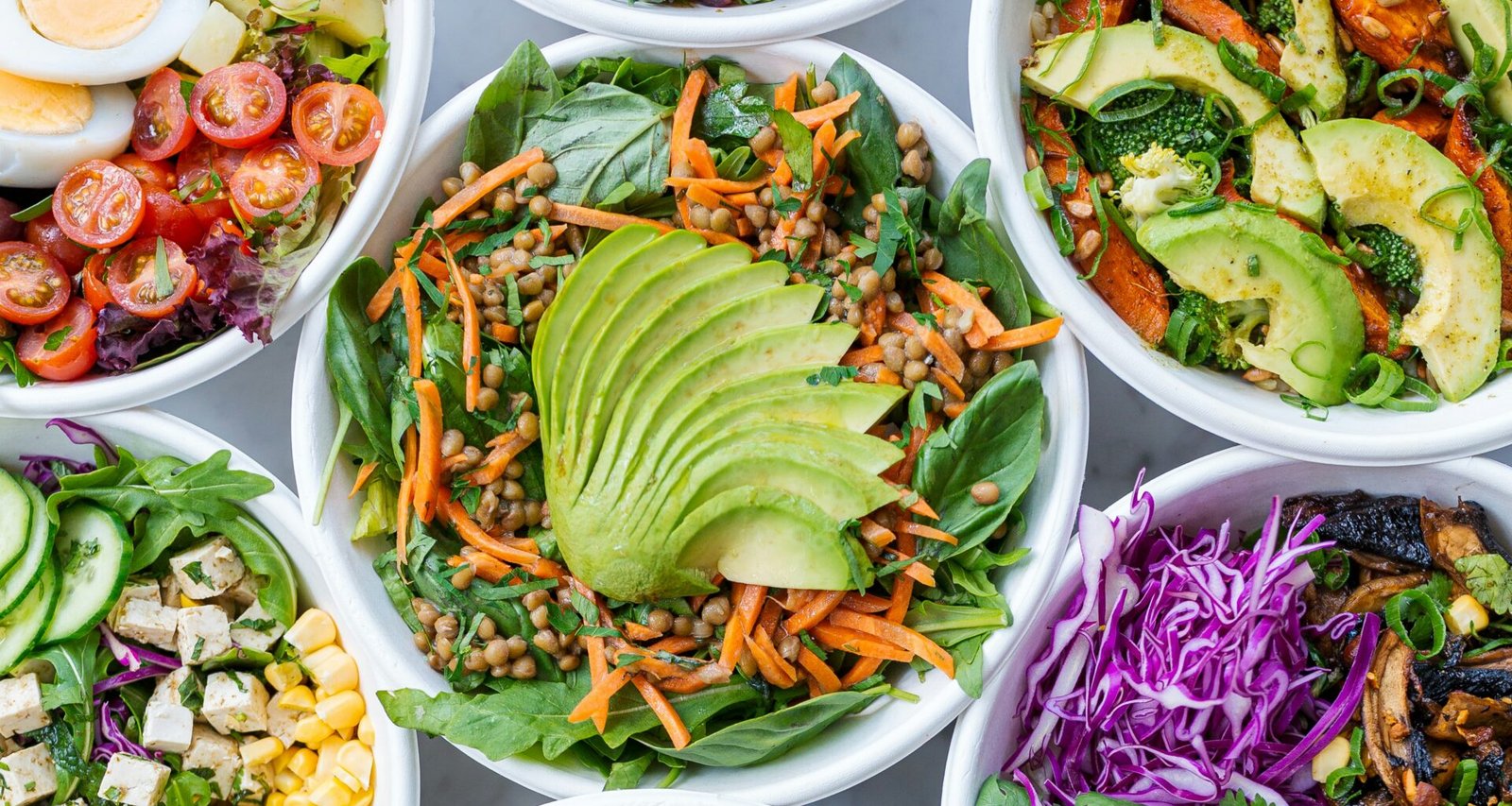 Photo of healthy white bowls filled with healthy, fresh Whole Foods and chicken for the article ‘What is culinary nutrition’.
