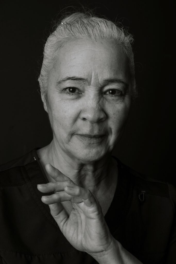 Black and white photo of an older, mixed race woman aging unapologetically.