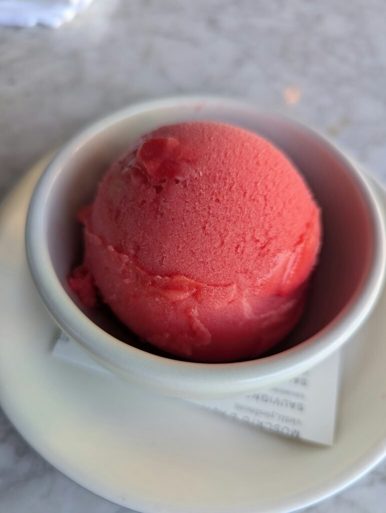 one round scoop of red sorbet